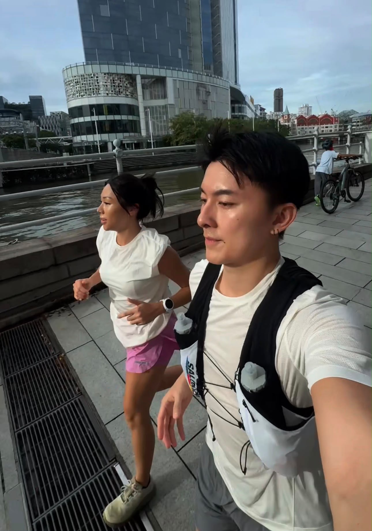 Edwin Goh and Rachel Wan running together beside the Singapore River